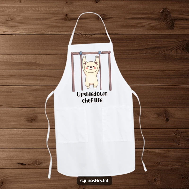 Funny Bear Gymnastics Apron: A proud bear hangs upside down from uneven bars, making this a humorous and practical kitchen essential.