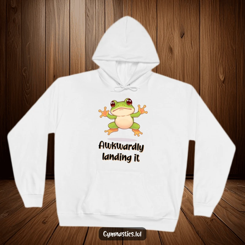 Funny frog hoodie showcasing a leaping frog landing face-first on its nose, a true comedic spectacle.