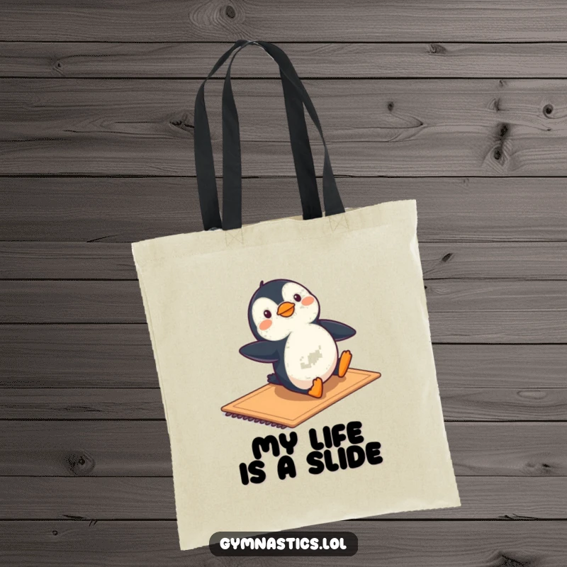 Funny tote bag with a penguin sliding playfully on a mat, perfect for carrying items with a dose of cheer.